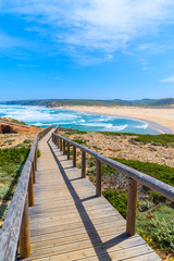 Fototapeta na wymiar Wooden walkway to Praia do Bordeira beach and beautiful blue sea view, Algarve region, Portugal
