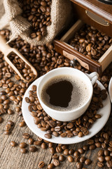hot coffee and coffee beans on the background of coffee grinders