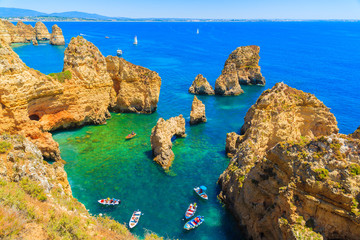 Fishing boats on turquoise sea water at Ponta da Piedade, Algarve region, Portugal