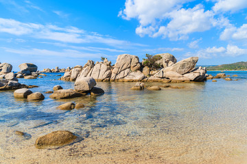 Rocks in sea water on Palombaggia beach, Corsica island, France