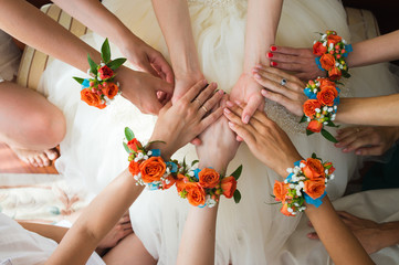 bridesmaids holding bride's hands