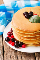 delicious pancakes on wooden table with fruits