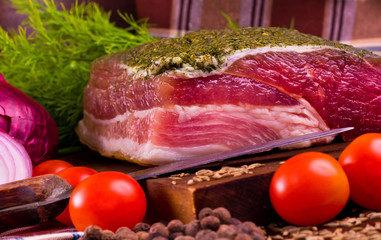 salted meat on the board with tomatoes, onions and dill