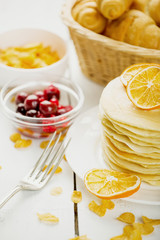 delicious pancakes on wooden table with fruits