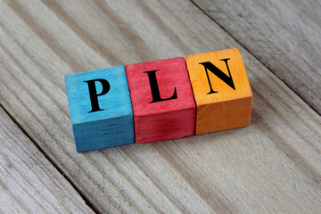 PLN (Polish Zloty) sign on colorful wooden cubes