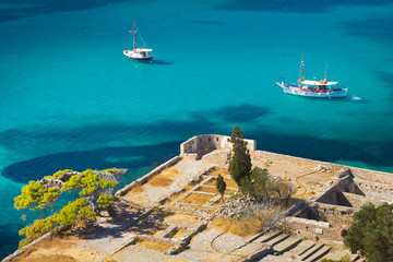 two ships in the bay near the island of Spinalonga