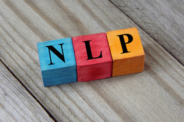 NLP (Neuro Linguistic Programming) sign on colorful wooden cubes