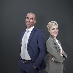 Composite image of  smiling business people back-to-back