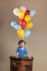 Little boy in a balloon - obrazy, fototapety, plakaty