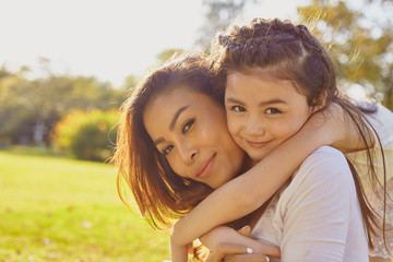 Lifestyle portrait mom and daughter in happines at the outside in the meadow
