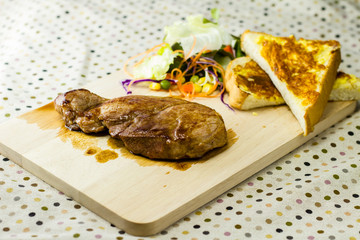 Grilled steaks on wood