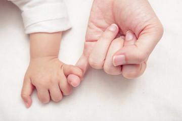 Mom and Baby making a pinkie promise, Soft focus and blurry (vin