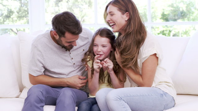 Parents playing with daughter