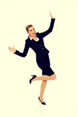 Fototapeta na wymiar Young happy jumping businesswoman
