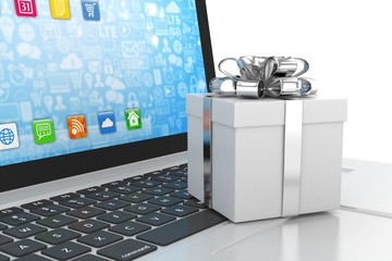 Gift box with ribbon on laptop keyboard
