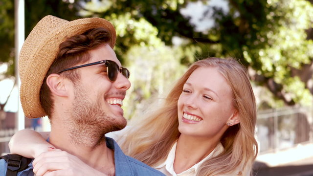 Smiling hipster couple looking at camera 