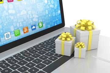 Gift box with ribbon on laptop keyboard