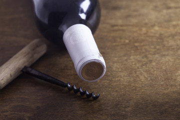 old corkscrew and bottle of wine on the board