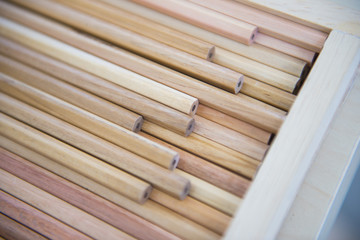 many wooden pencils in a wooden box