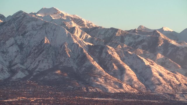 The Wasatch mountain range over looks the Salt Lake City valley at sunset.