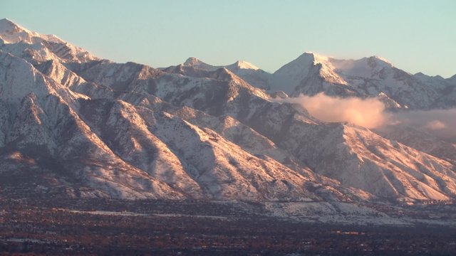 The Wasatch mountain range over looks the Salt Lake City valley at sunset.