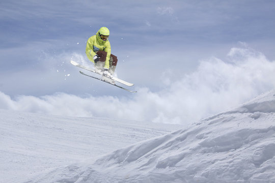 Flying skier on mountains. Extreme ski sport.