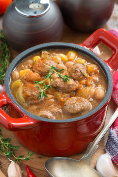 vegetable stew with sausages in a pan, top view vertical