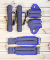 Sport Equipment. Dumbbells, Ankle Weights And Wrist Weights On Boards. Sport Fitness Background