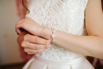 Obraz na płótnie Canvas bride getting bracelet dressed on her wedding day