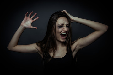 Portrait of a scared screaming girl, hands on the forehead