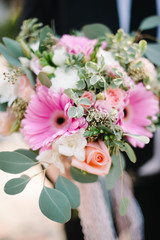 Groom holding a wedding bouquet