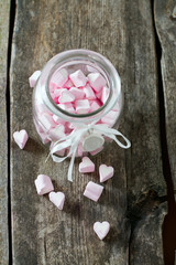 heart-shaped marshmallows on wooden surface