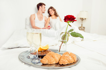Obraz na płótnie Canvas Couple in love having romantic breakfast in bedroom