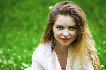Naklejka premium Young blonde woman on green meadow