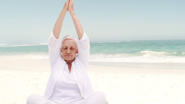 Old retired woman doing some yoga