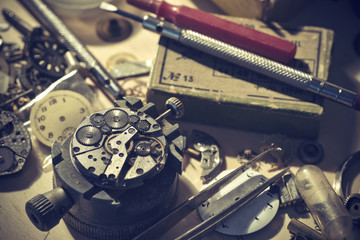 Old Watchmaker Studio. A watch makers work top. The inside workings of a vintage mechanical watch.