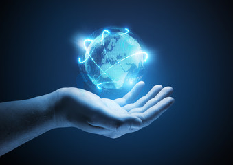 Connected World. Conceptual business  illustration. A man holding a glowing projection of the world.