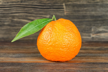 Orange with leavfe on wood