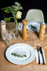 Decorated table ready for dinner. Beautifully decorated table set with flowers, candles, plates and serviettes for wedding or another event in the restaurant.