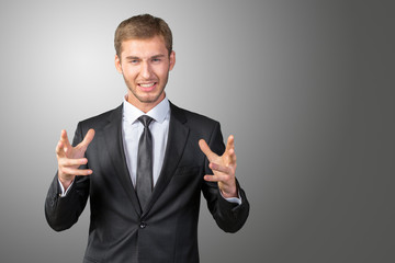 Scared and astonished young businessman