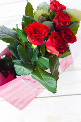 Red roses and gift bag