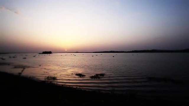 Locked-on shot of a lake at sunset, Bhopal, Madhya Pradesh, India