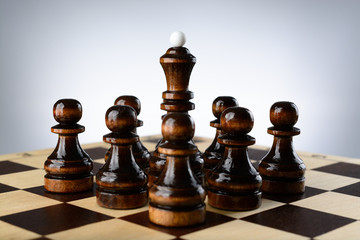 Fototapeta premium Black queen surrounded by pawns