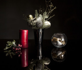Candle and Christmas decorations on a glass table