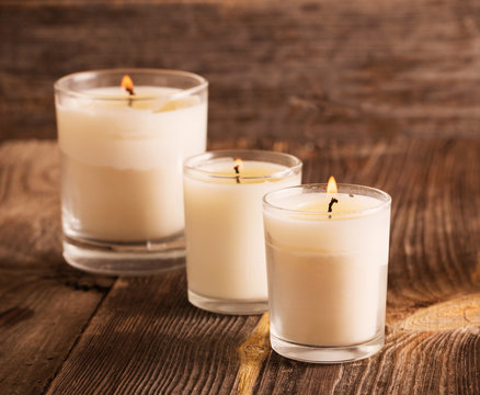scented candles on old wooden background