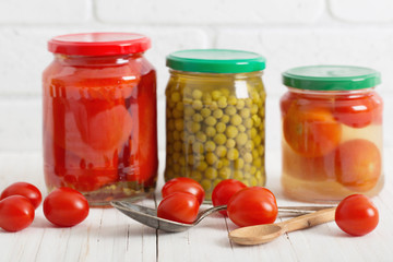 Jars with pickled vegetables on white background