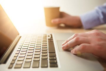 The hand on the keyboard and coffee