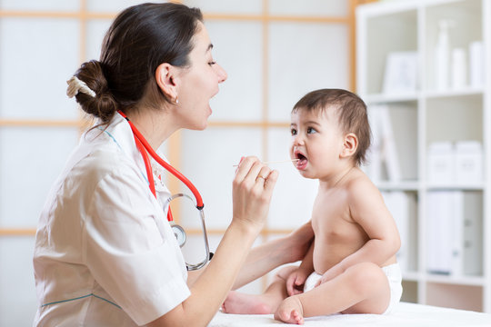 doctor examining little girl baby