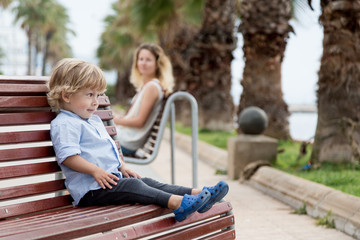 Little boy sitting on the bench
