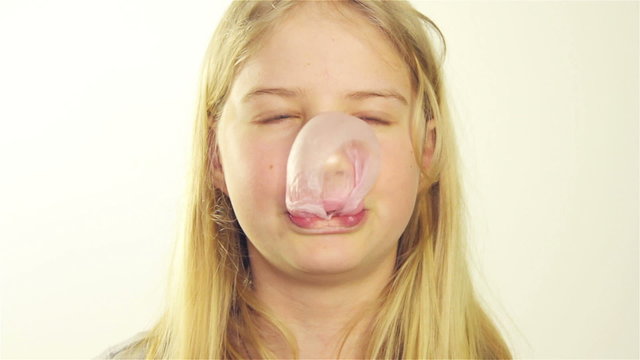 Girl inflates the bubble from chewing gum